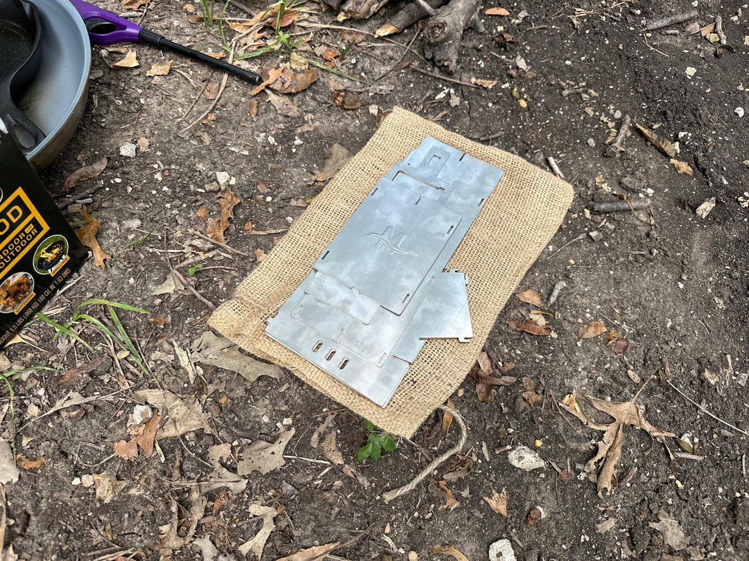 Collapsed rocket stove. Flattens for easy storage and transport.