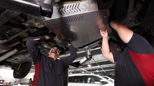 Installers at a local Toyota dealer installing a Miller CAT Cat Shield on a Tundra.