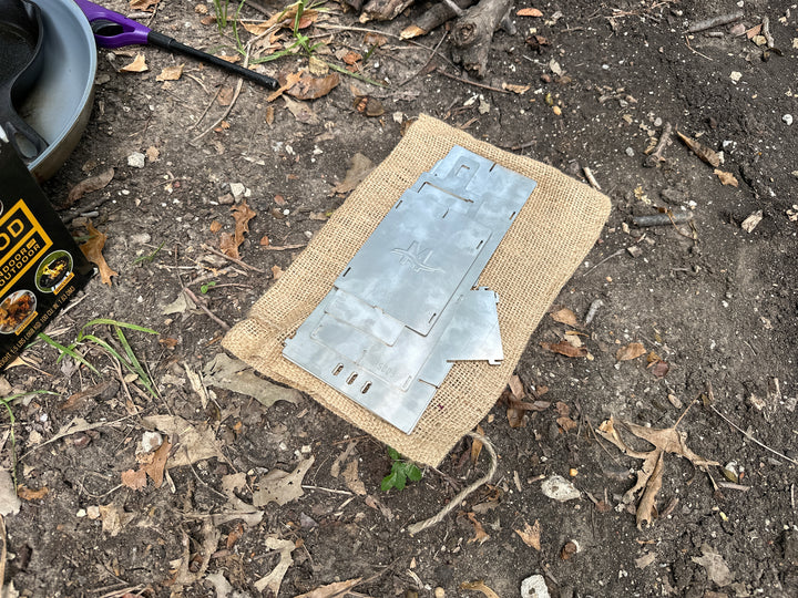 Collapsed rocket stove. Flattens for easy storage and transport.